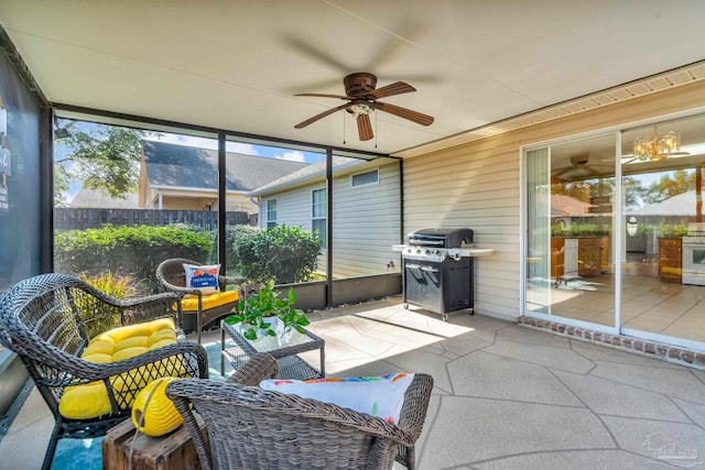 sunroom / solarium featuring ceiling fan