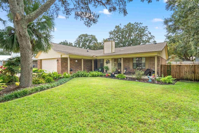 ranch-style house featuring a front yard and a garage