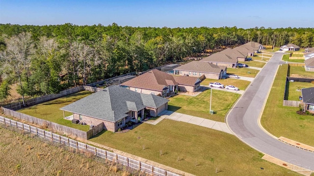 birds eye view of property featuring a view of trees