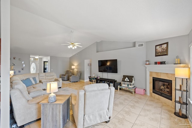 1307 Mazurek Blvd, Pensacola, FL 32514 - living room featuring lofted ceiling, a ceiling fan, a tile fireplace, and light tile patterned flooring