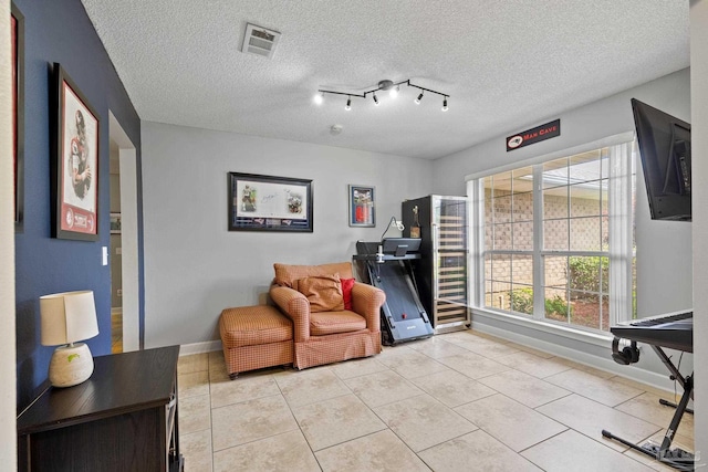 1307 Mazurek Blvd, Pensacola, FL 32514 - living area with baseboards, a textured ceiling, and light tile patterned flooring