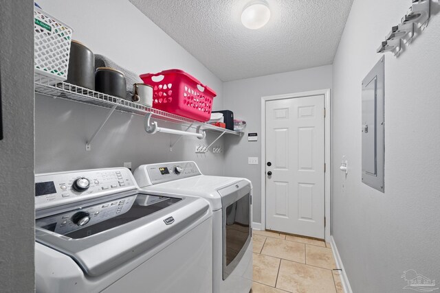 1307 Mazurek Blvd, Pensacola, FL 32514 - laundry room with washing machine and dryer, a textured ceiling, light tile patterned floors, baseboards, and electric panel