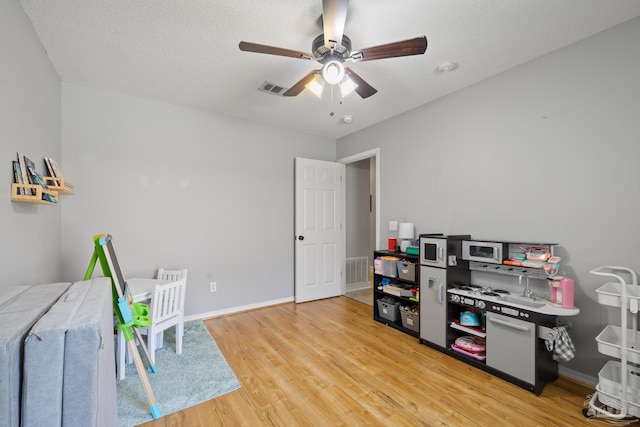 1307 Mazurek Blvd, Pensacola, FL 32514 - playroom featuring wood finished floors, ceiling fan, and baseboards