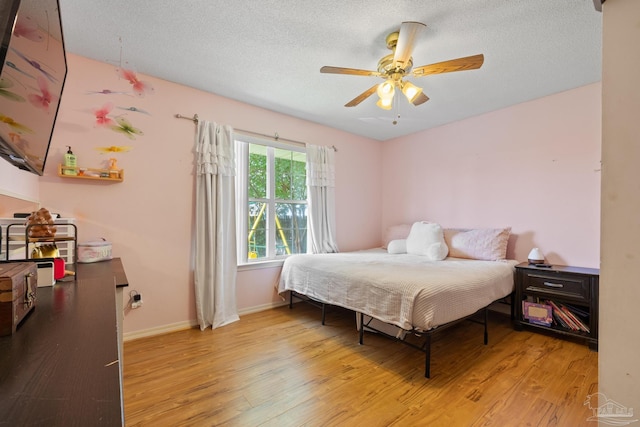 1307 Mazurek Blvd, Pensacola, FL 32514 - bedroom featuring light wood-style flooring, baseboards, ceiling fan, and a textured ceiling