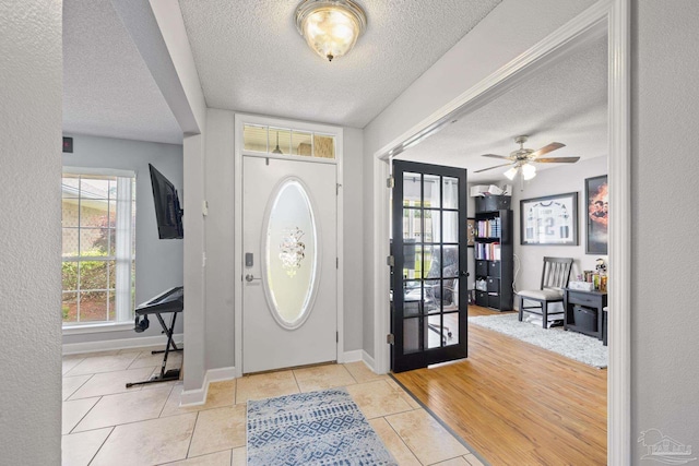 1307 Mazurek Blvd, Pensacola, FL 32514 - tiled foyer entrance with a textured ceiling, baseboards, and ceiling fan