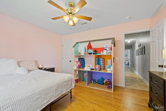 1307 Mazurek Blvd, Pensacola, FL 32514 - bedroom with light wood-style flooring, baseboards, and a ceiling fan
