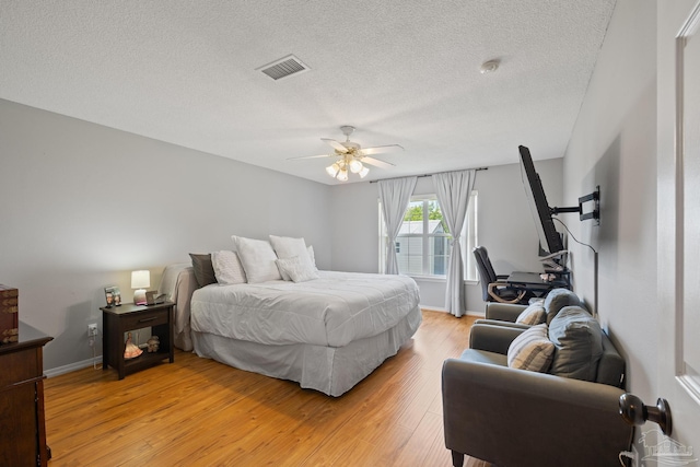 1307 Mazurek Blvd, Pensacola, FL 32514 - bedroom with light wood-type flooring, baseboards, a textured ceiling, and ceiling fan