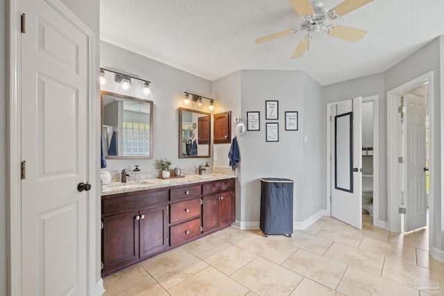 1307 Mazurek Blvd, Pensacola, FL 32514 - full bathroom with double vanity, ceiling fan, a textured ceiling, tile patterned flooring, and toilet