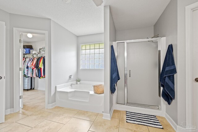 1307 Mazurek Blvd, Pensacola, FL 32514 - bathroom with a bath, a stall shower, a spacious closet, tile patterned floors, and a textured ceiling