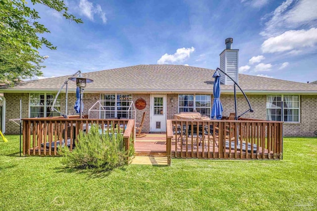 1307 Mazurek Blvd, Pensacola, FL 32514 - back of house with brick siding, a chimney, a lawn, a deck, and roof with shingles
