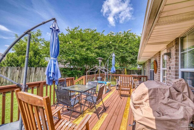 1307 Mazurek Blvd, Pensacola, FL 32514 - wooden deck with outdoor dining area and a fenced backyard