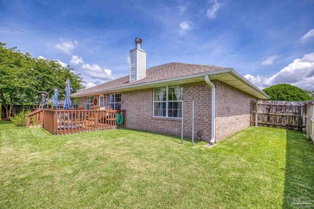 1307 Mazurek Blvd, Pensacola, FL 32514 - rear view of house with brick siding, a chimney, a deck, and a shingled roof