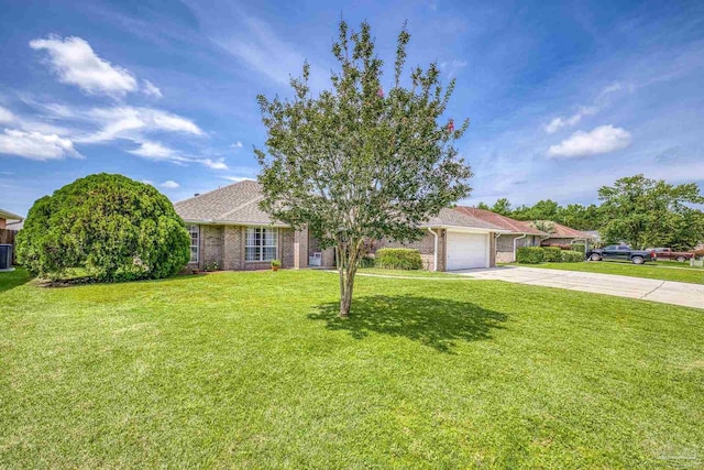 1307 Mazurek Blvd, Pensacola, FL 32514 - obstructed view of property with concrete driveway, a garage, brick siding, a front lawn, and central AC