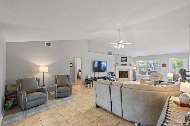 1307 Mazurek Blvd, Pensacola, FL 32514 - living area featuring vaulted ceiling, light tile patterned flooring, a ceiling fan, a fireplace, and baseboards