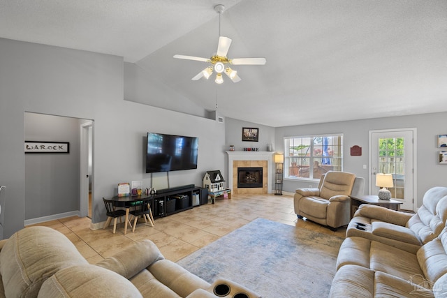 1307 Mazurek Blvd, Pensacola, FL 32514 - living room with a ceiling fan, light tile patterned flooring, lofted ceiling, baseboards, and a tile fireplace