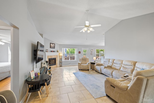 1307 Mazurek Blvd, Pensacola, FL 32514 - living area with a ceiling fan, vaulted ceiling, a tiled fireplace, and light tile patterned floors