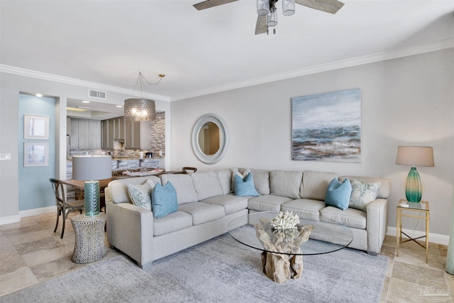 living room with crown molding and ceiling fan