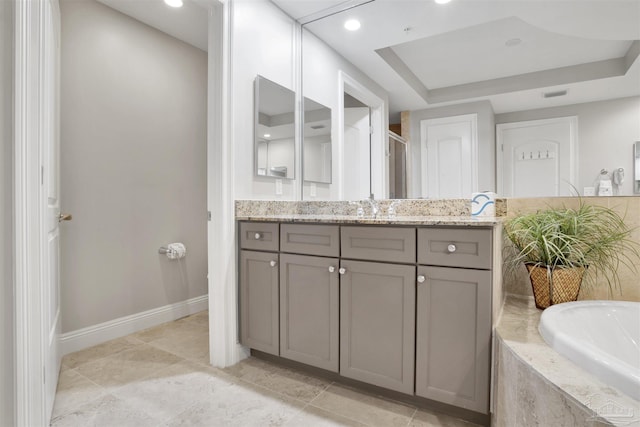 bathroom featuring vanity, plus walk in shower, and a raised ceiling