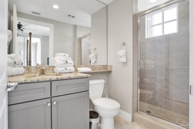 bathroom with vanity, a shower with shower door, tile patterned floors, and toilet