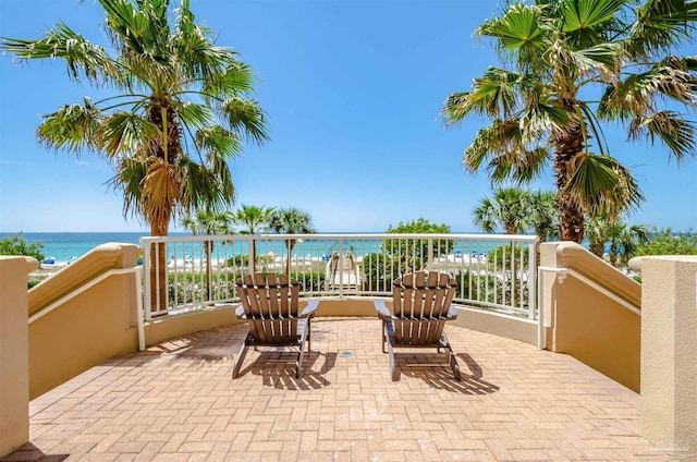 view of patio / terrace with a balcony and a water view