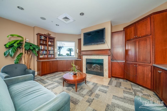 living room with a tile fireplace