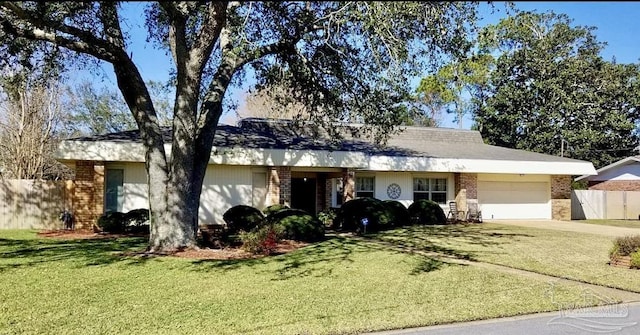 single story home with a garage, fence, a front lawn, and brick siding