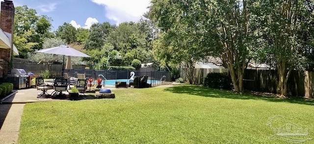 view of yard featuring a patio area, a fenced backyard, and a fenced in pool