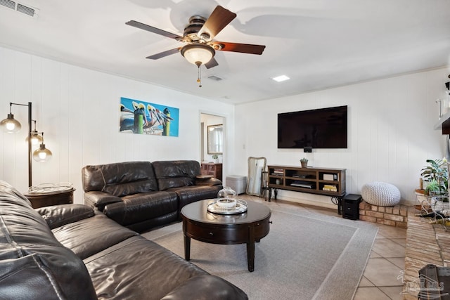 living room featuring light tile patterned floors, ceiling fan, and visible vents