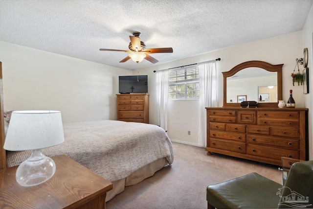 bedroom with light carpet, ceiling fan, and a textured ceiling