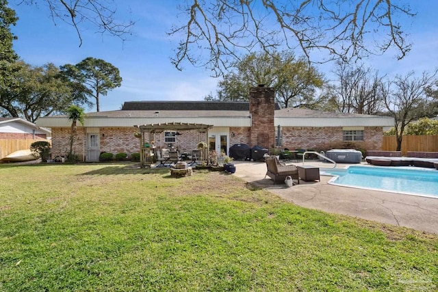 rear view of house featuring a patio, fence, french doors, a lawn, and a fenced in pool