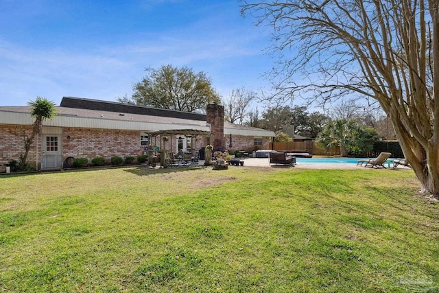 view of yard with an outdoor pool, a fenced backyard, and a patio