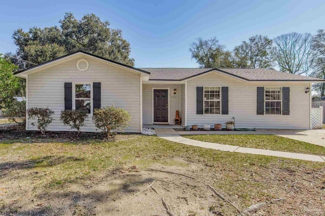 ranch-style home featuring a front yard