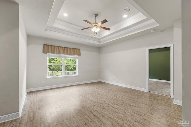 3526 Whitetail Ln, Pensacola, FL 32526 - spare room with ornamental molding, ceiling fan, wood finished floors, a tray ceiling, and baseboards