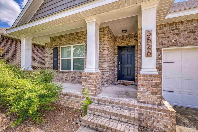3526 Whitetail Ln, Pensacola, FL 32526 - view of exterior entry with a porch, brick siding, and a garage