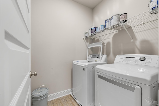 3526 Whitetail Ln, Pensacola, FL 32526 - washroom with separate washer and dryer, light wood-style floors, and baseboards