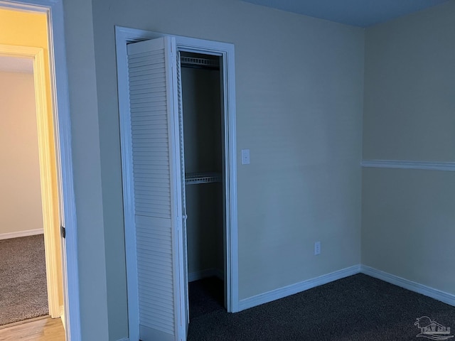 unfurnished bedroom featuring a closet and carpet