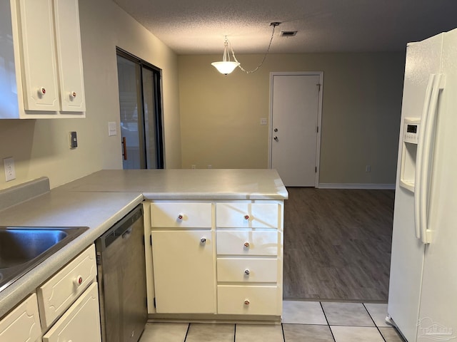 kitchen with white cabinetry, hanging light fixtures, stainless steel dishwasher, kitchen peninsula, and white refrigerator with ice dispenser