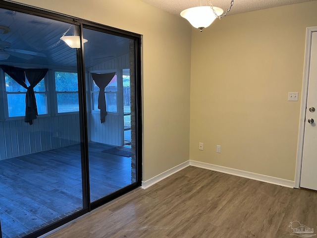 unfurnished room featuring ceiling fan, hardwood / wood-style floors, and a textured ceiling