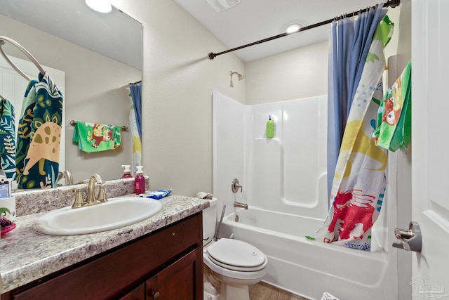 full bath featuring wood finished floors, vanity, toilet, and shower / bath combo with shower curtain