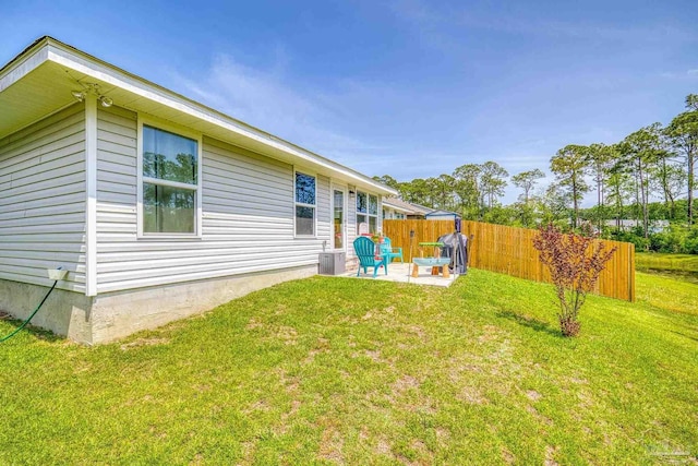 view of yard featuring fence and a patio