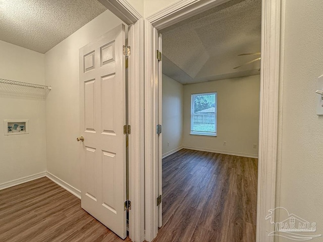 laundry area with washer hookup, ceiling fan, dark hardwood / wood-style flooring, and a textured ceiling