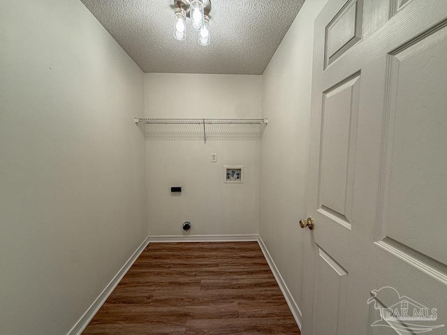 clothes washing area with hookup for an electric dryer, washer hookup, a textured ceiling, and dark wood-type flooring