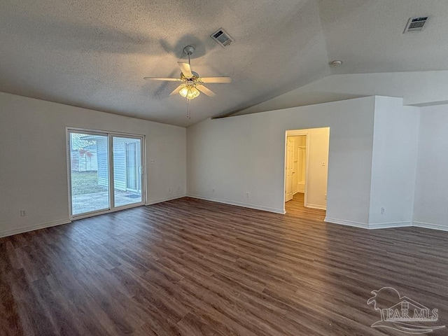 empty room with a textured ceiling, ceiling fan, dark wood-type flooring, and vaulted ceiling