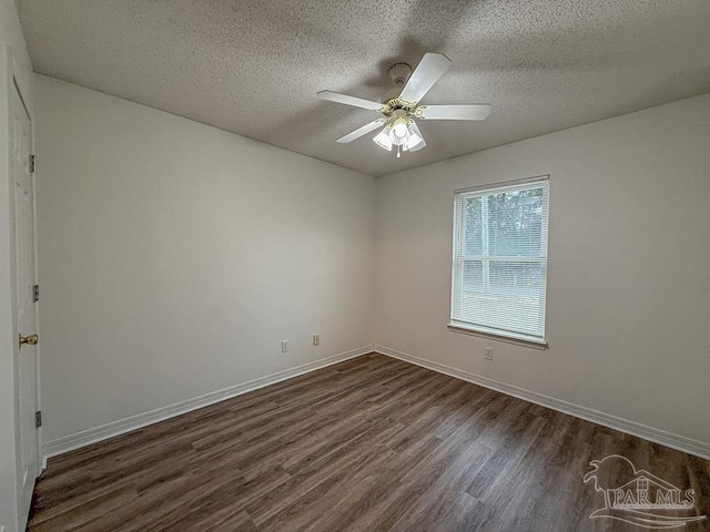 unfurnished room featuring ceiling fan, dark wood-type flooring, and a textured ceiling