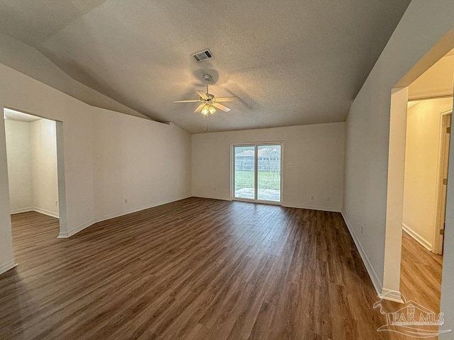 unfurnished room with ceiling fan, dark hardwood / wood-style flooring, lofted ceiling, and a textured ceiling