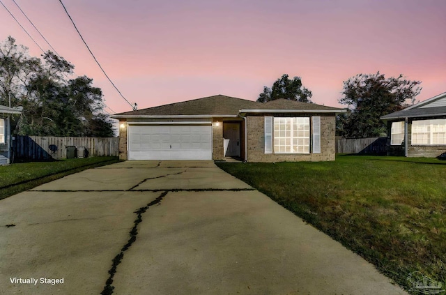 view of front of home with a lawn and a garage