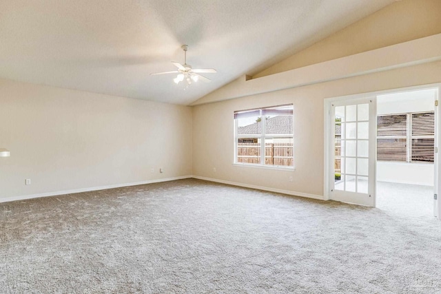 carpeted spare room featuring ceiling fan and lofted ceiling