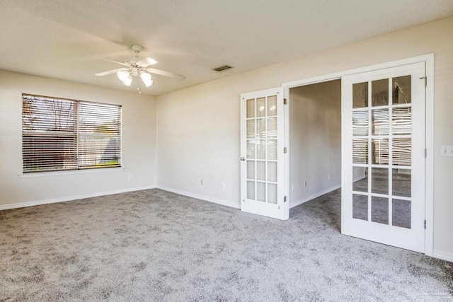 spare room with ceiling fan, carpet floors, and french doors