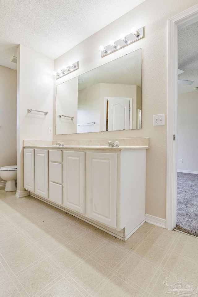 bathroom featuring vanity and a textured ceiling