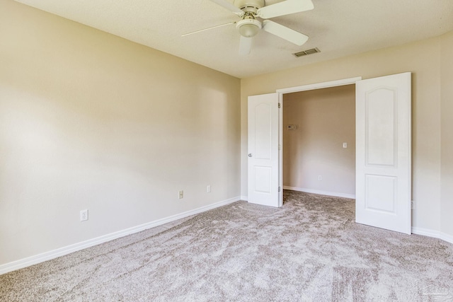 unfurnished bedroom with ceiling fan and light carpet